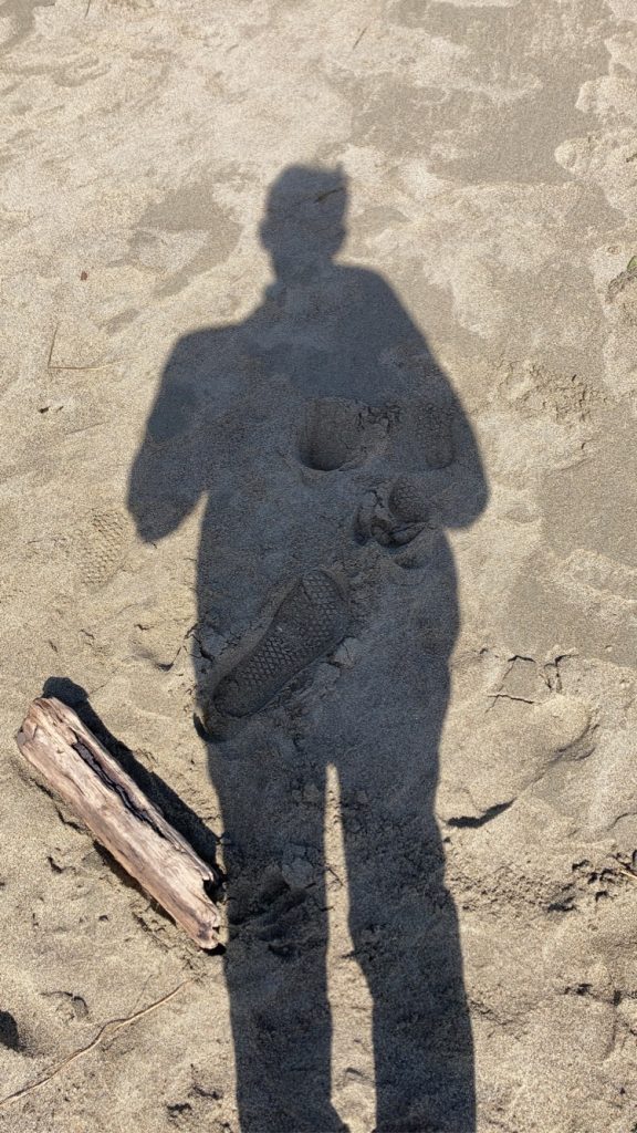 Garrett Porter's shadow standing on the beach